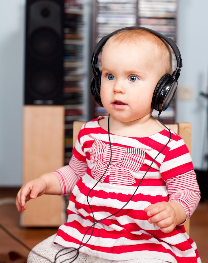 Bébé assis avec les écouteurs sur la tête